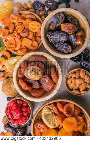 Assortment Of Nuts And Dried Fruits. Dried Fruits And Nuts Mix In A Wooden Bowl. Assortment Of Candi