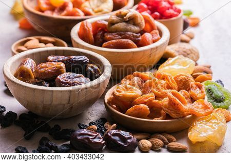 Assortment Of Nuts And Dried Fruits. Dried Fruits And Nuts Mix In A Wooden Bowl. Assortment Of Candi
