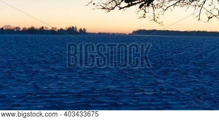 A Close View Over A Snow Field While Sunset