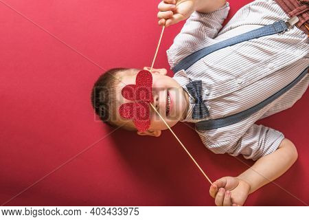 Five Year Old Smiling Boy Holding A Red Heart On Eays  Symbol Of Love, Family, Hope. Backgrounds For