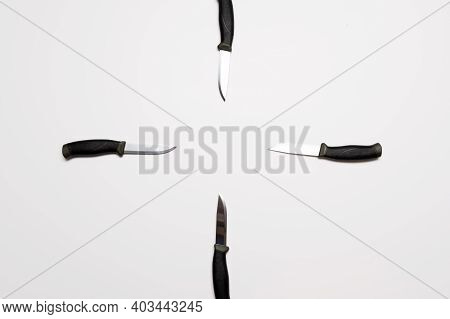 Target-shaped Knives. Several Knives On A Gray Background. Target Of Knives.