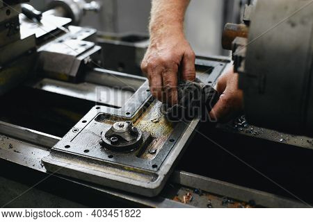 Service And Repair Of Machine Tools In A Machine Shop Or Workshop. These Are The Hands Of A White Ma