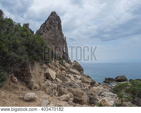 View Of Pedra Longa, Limestone Rock Pillar At Coast Gulf Of Orosei, Beginning Of The Famous And Diff