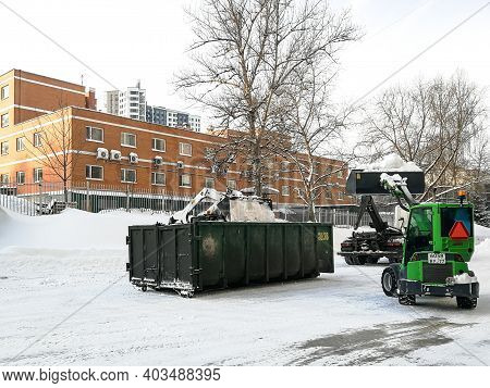 Moscow. Russia. January 15, 2021. Small Front-end Loaders Clear Snow From The Street And Load Into A