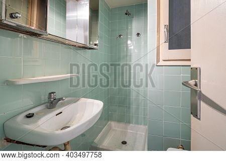Empty, Old And Dirty Bathroom With Blue Tiles In An Old House Of Barcelona