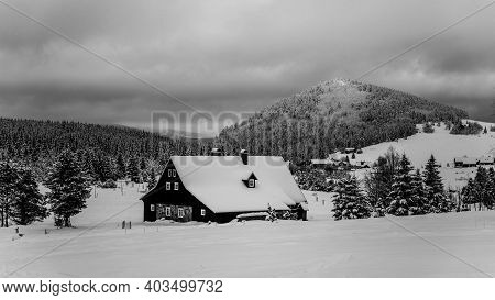Jizerka Village And Bukovec Mounain In Winter. Jizera Mountains, Czech Republic. Black And White Ima
