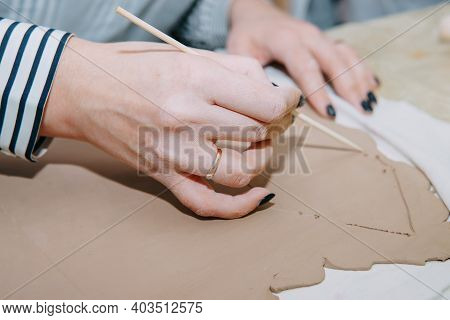 Women's Hands Knead Clay, Drawing Elements Of The Product. Production Of Ceramic Products At The Mas