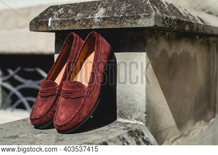 Brown Leather Moccasins. Photo On The Street On The Wall. Trendy Brown Loafers.