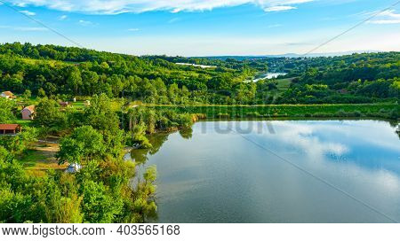 Above View Over Embankment, Dam Of Lake At Hilly Landscape, Woodland, Rural Road. Near Is Another La