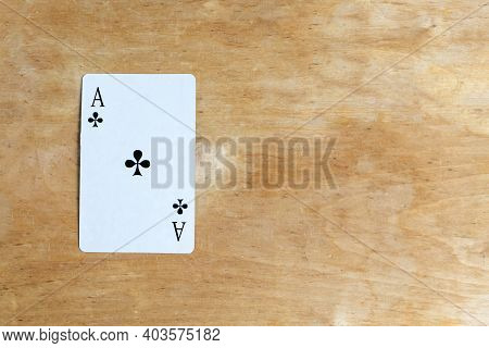 Ace Of Сlubs Playing Card On Wooden Background, Top View, Copy Space
