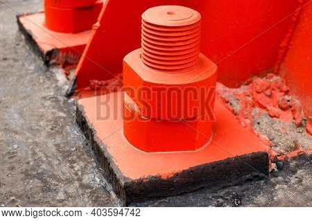 The Red Metal Support Is Bolted To The Concrete Base With Large Bolts. Fixing A Tower Or Tower To Th