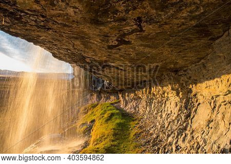 Sunset Behind Waterfall Bergarfoss In Hornafjordur In South Icelandic Countryside