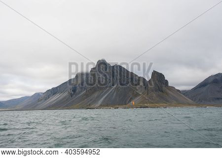 Eystrahorn Mountain And Hvalnes Lighthouse In The Coastal Countryside Of East Iceland