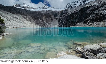 Vibrant Blue Waters Of Lagoon 69 With Chakrarahu Peak, Peru.