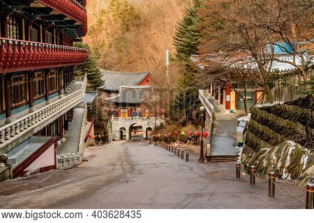 Danyang-gun, South Korea; Jan. 13, 2021: Buildings Of Guinsa Temple On Hillside With Gate In Backgro