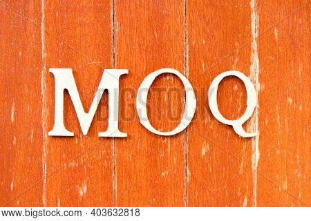 Alphabet Letter In Word Moq (abbreviation Of Minimum Order Quantity) On Old Red Color Wood Plate Bac