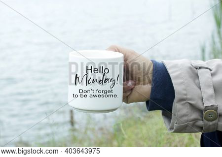 Monday Inspirational Quote - Hello Monday. Do Not Forget To Be Awesome. Person Holding A Cup Of Morn