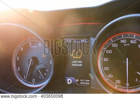 Low Tire Pressure Error Sign. Warning Lights Flash On The Car Dashboard.