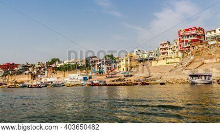 Varanasi, India - May 06, 2019 - A View Of Historic Varanasi Ghats, Ancient Temples And Buildings Al