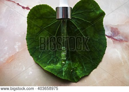 Gold Particles Glittering Serum Bottle With Dropper.
Concept Natural Organic Cosmetic.cosmetics With