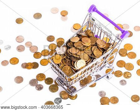 Supermarket Metal Basket On Wheels With Metal Money Coins On White Background - Multicurrency Basket