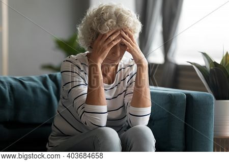 Unhealthy Old Senior Retired Woman Suffering From Strong Headache.
