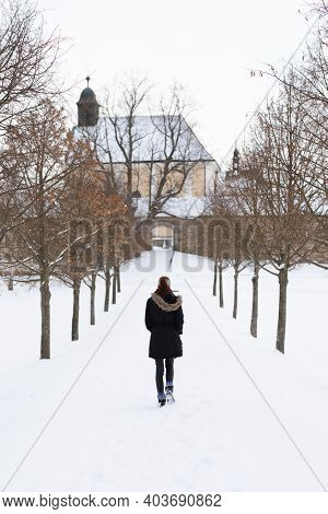 Girl From Behind On The Snowy Winter Path Going To Church