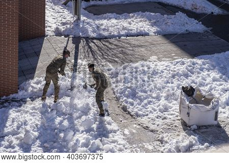 Madrid, Spain - January 17: Army Soldiers Clean The Streets Of Snow With Shovels After The Filomena 