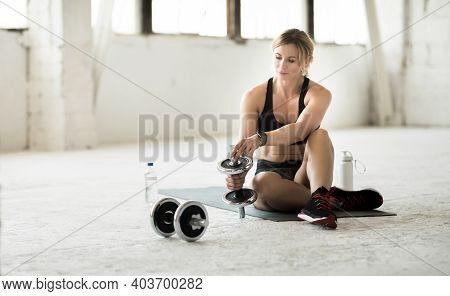 Modern Workout During Covid-19 At Home Or Gym In Self-isolation. Busy Slim Muscular Mature Woman In 