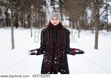 Photo Of Happy Young Girl In Winter Clothes With Snow In Her Hands