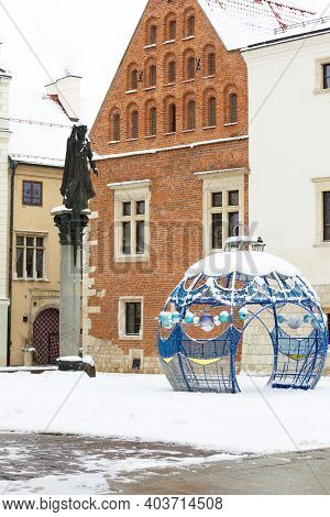 Krakow, Poland - January 17, 2021: Snowy Winter In Krakow, Saint Mary Magdalene Square And Monument 