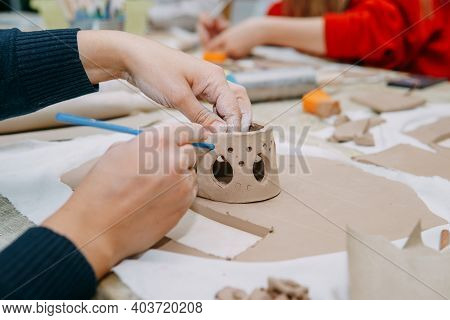 Women's Hands Knead Clay, Drawing Elements Of The Product. Production Of Ceramic Products At The Mas