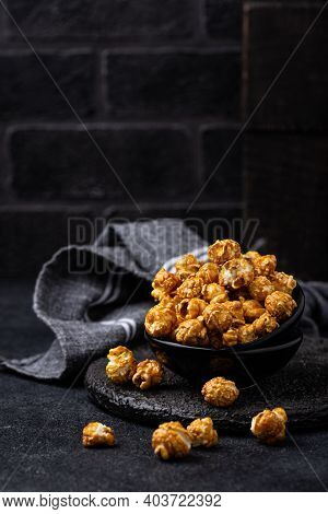 Salted Caramel Popcorn In Bowl On Dark Background