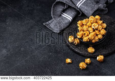 Salted Caramel Popcorn In Bowl On Dark Background