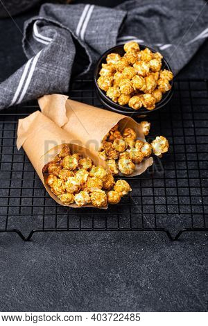 Salted Caramel Popcorn In Bowl On Dark Background