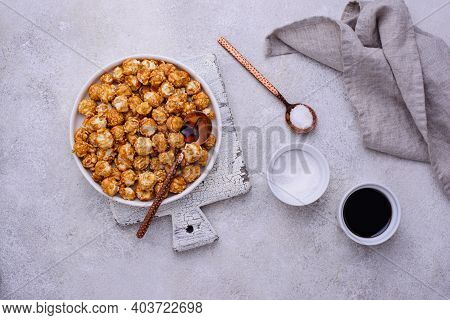 Salted Caramel Popcorn In Bowl On Light Background