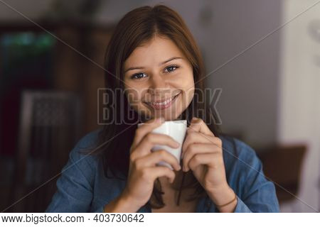 Beautiful Girl In Cafe With Cup Of Hot Chocolade Or Coffee