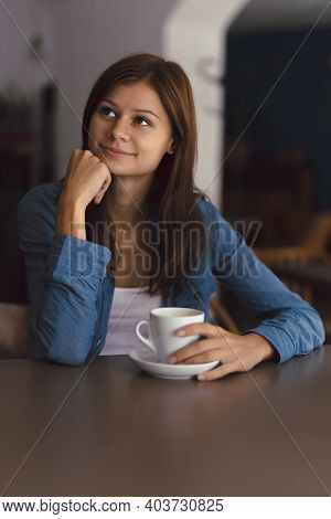 Cute Girl In Cafe With Cup Of Hot Chocolade