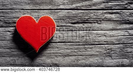 Red heart on a wooden background concept for love, dating and romance with coyspace