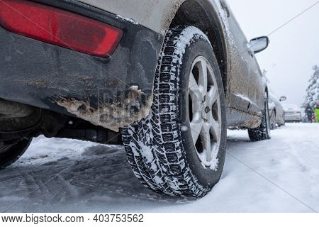 Winter tire. Car on snow road. Tires on snowy highway detail stock photo