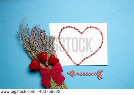 Valentines Day Congratulation. Red Rose And Greeting Card With Heart Sign On Blue Background Top Vie