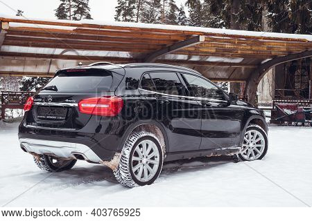 MOSCOW, RUSSIA-JANUARY 10, 2021: Black luxury crossover Mercedes Benz GLA 250 on a suburban plot in