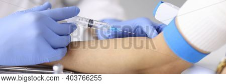 Doctor Injecting Medication Into Patients Ulnar Vein At Clinic Closeup. Emergency Care Concept