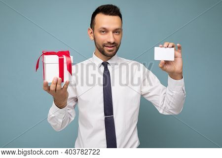 Photo Shot Of Handsome Happy Brunette Young Unshaven Man With Beard Isolated Over Blue Background Wa