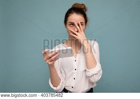 Photo Of Attractive Angry Upset Young Blonde Curly Woman Wearing Casual White Shirt Isolated Over Bl