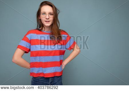 Pretty Shy Young Female Student Standing Isolated Over Blue Background Wall Keeping Hands Behind Loo