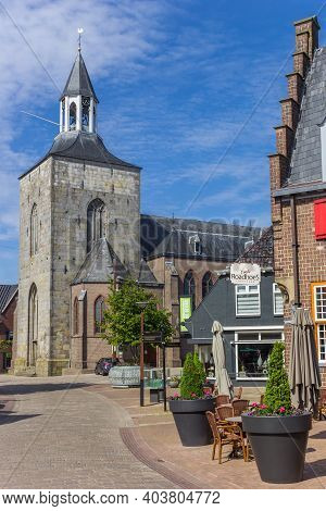 Tubbergen, Netherlands - May 26, 2020: Cobblestoned Street Leading To The Pancratius Church In Tubbe