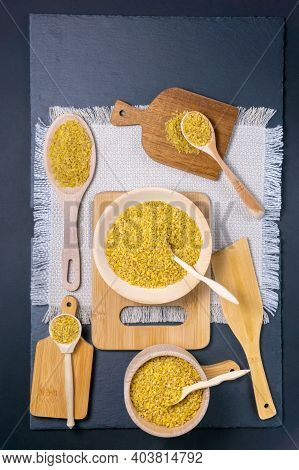 Bulgur, A Bunch Of Bulgur Next To The Village With A Spoon In Which Bulgur, On A Black Background. V