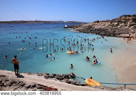 Qala, Malta - August 15, 2019: Many Unidentified People On The Beach Of Hondoq Bay. Island Of Gozo. 