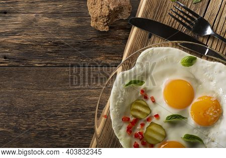 Banner Fried Eggs Sunny Side Up On A Rustic Table With Copy Space.
